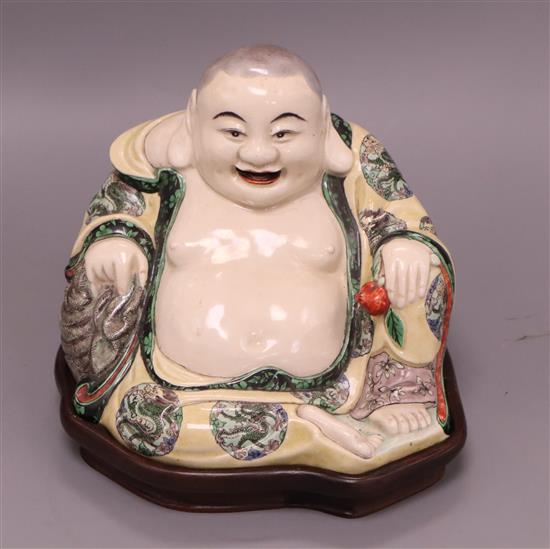 A Chinese famille verte Buddha, on fitted hardwood stand overall height 19cm